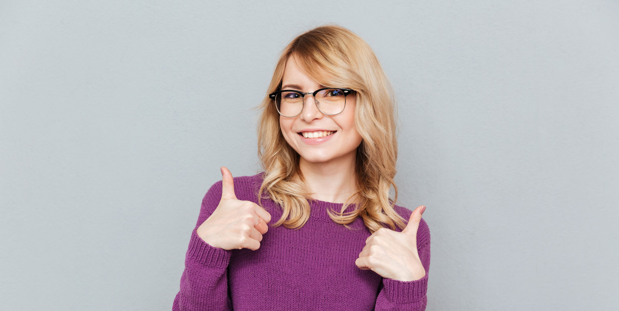 Smiling student showing thumbs up